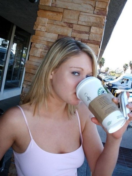 Cute blond girl smokes a cigarette before unleashing her natural tits in jeans
