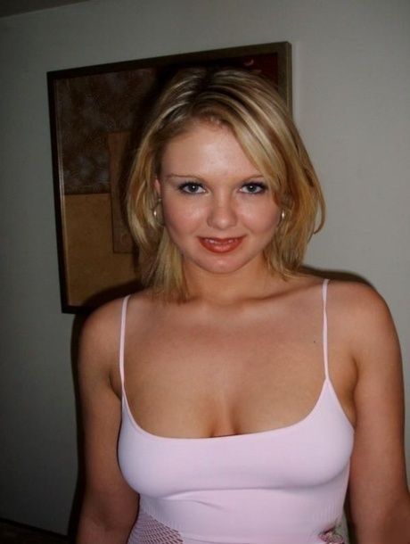 Cute blond girl smokes a cigarette before unleashing her natural tits in jeans