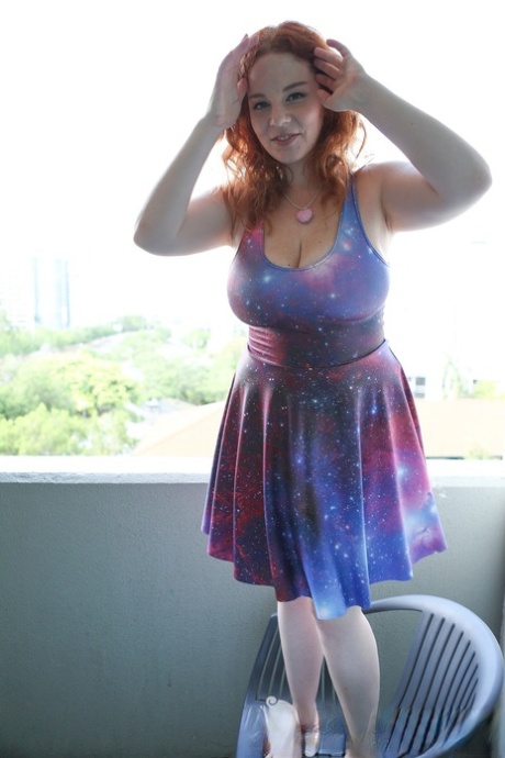 Chubby solo girl with curly red hair unleashes her incredible breasts