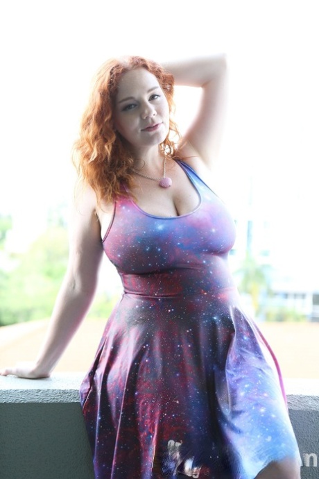 Chubby solo girl with curly red hair unleashes her incredible breasts
